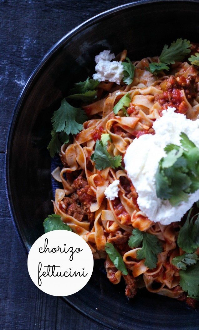 a heart chorizo tomato pasta topped with creamy ricotta and fresh cilantro