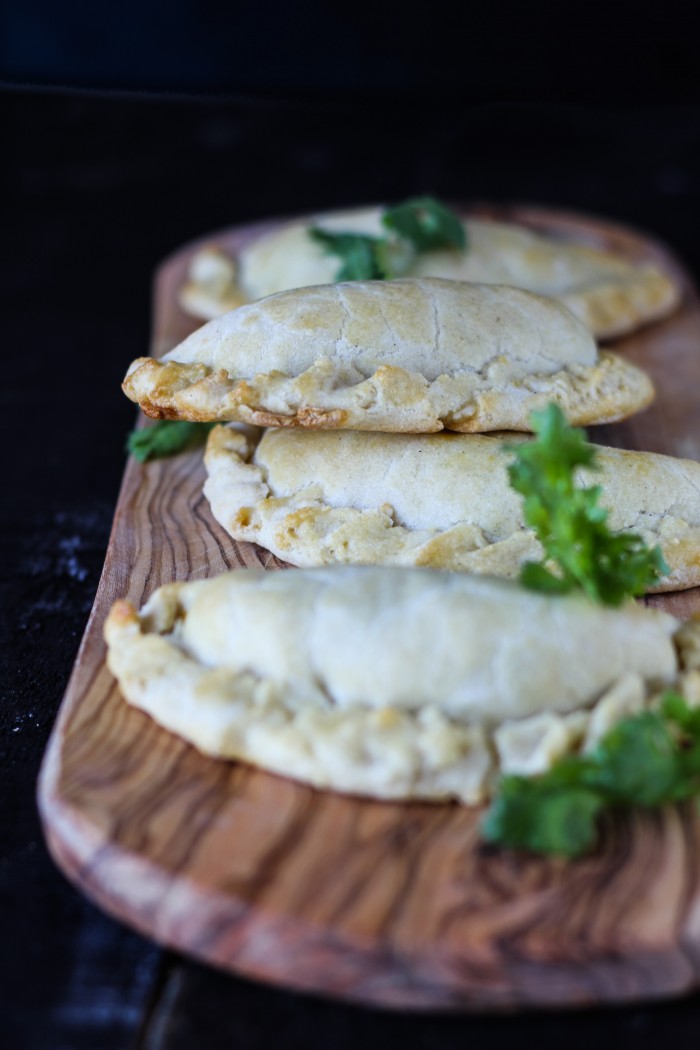 lightly spiced sweet potatoes and kale make a hearty filling for empanadas served with cilantro chimichurri